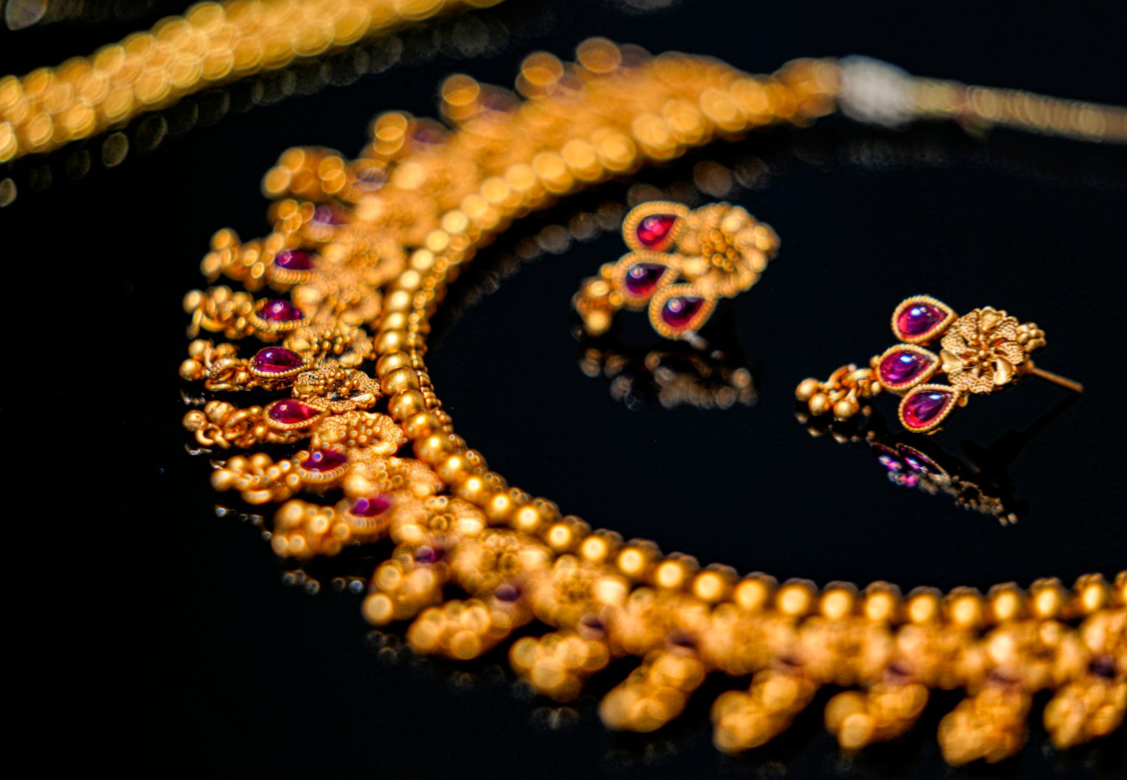 Gold jewellery with coloured gemstone details
